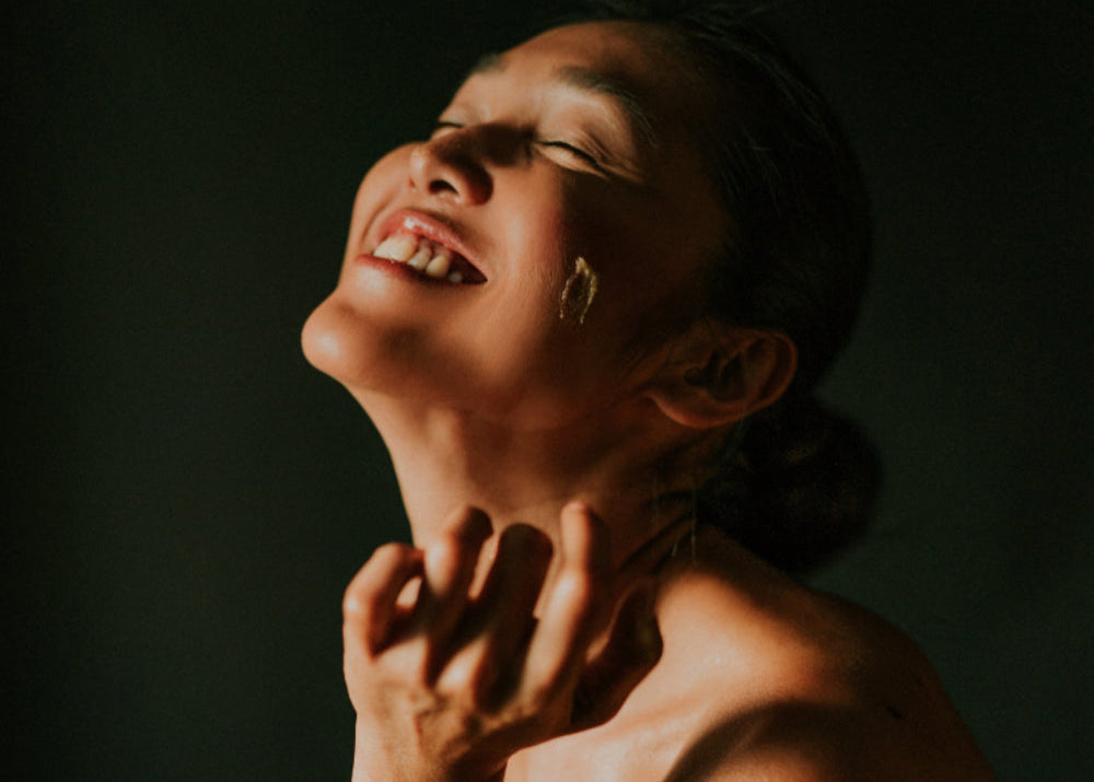 A lady using the mekha exfoliating cleanser.